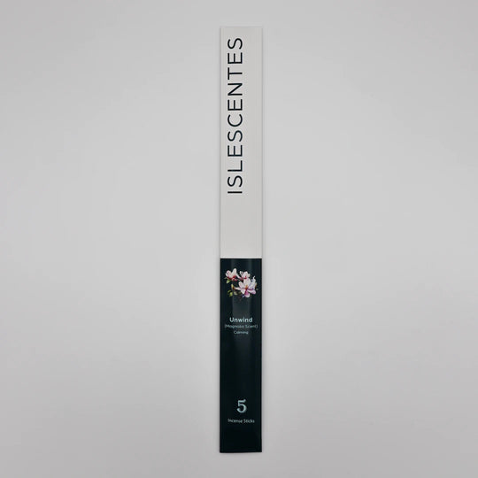 ISLESCENTES Unwind Magnolia Incense Stick product packaging on a gray background
