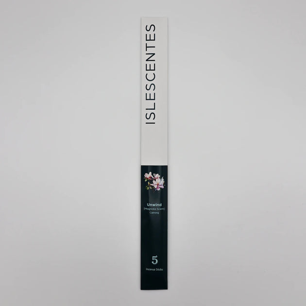 ISLESCENTES Unwind Magnolia Incense Stick product packaging on a gray background
